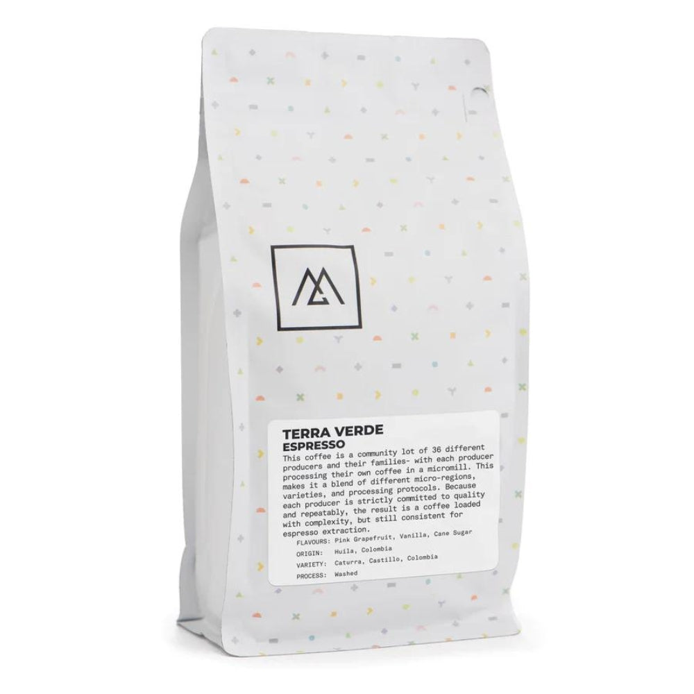 LAMOSE compatible: White Monogram Coffee Terra Verde espresso bag, multi-color specs, front angle, showing text details & logo.
