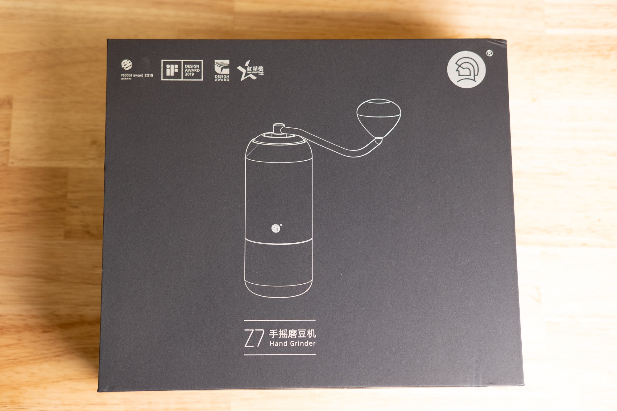 Dark grey cardboard box for zeroHero Z7 Manual Hand Grinder, featuring product outline, design awards, and branding, top-down view. LAMOSE.