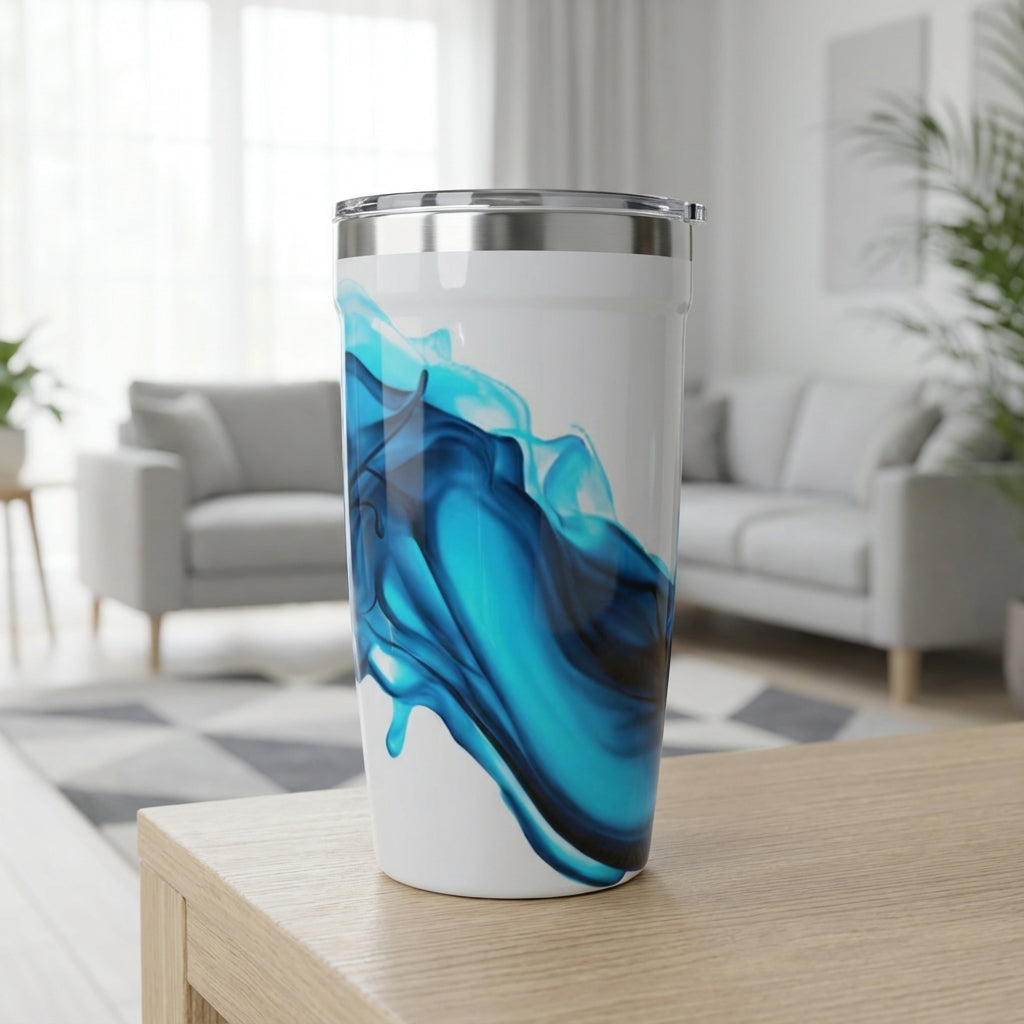 LAMOSE Peyto 16 oz white travel cup featuring a deep blue abstract ink swirl design, standing on a textured surface.