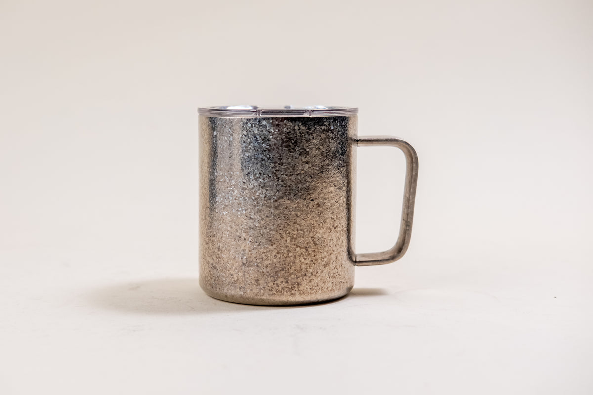Full view of the Hudson Titanium 12 oz mug, displaying its robust handle and granular titanium surface under a securely closed lid, exemplifying a blend of rustic elegance and functional design.