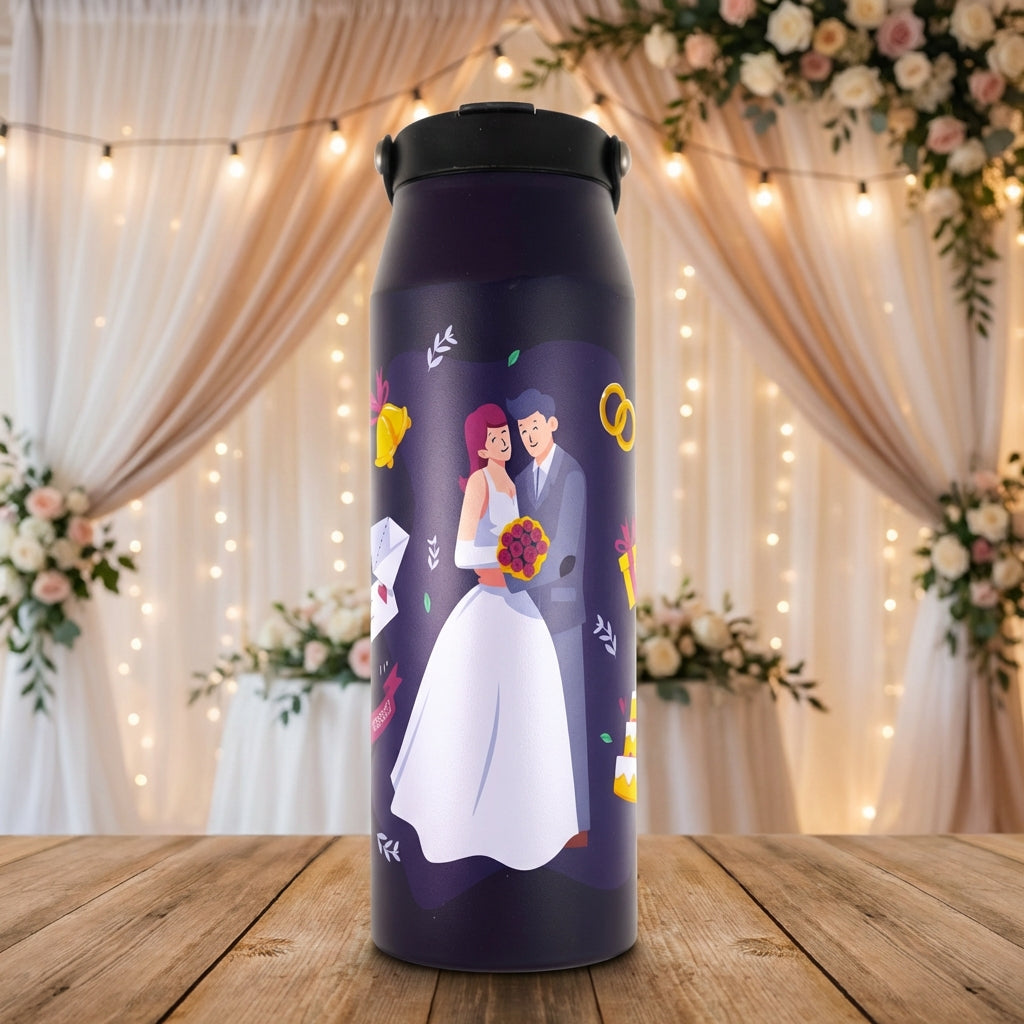 Dark blue Grouse 34 oz tumbler featuring a whimsical cartoon illustration of a red-haired bride and blue-haired groom with wedding bells and cake.