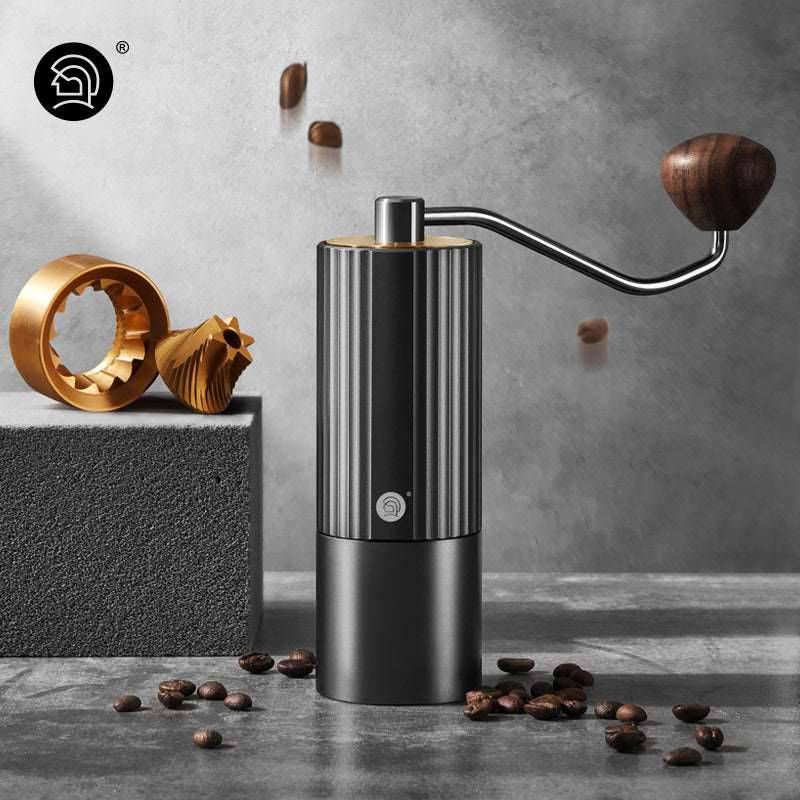 LAMOSE zeroHero Z3 Pro manual coffee grinder with a black ribbed body, golden high-precision burrs, and wooden handle.