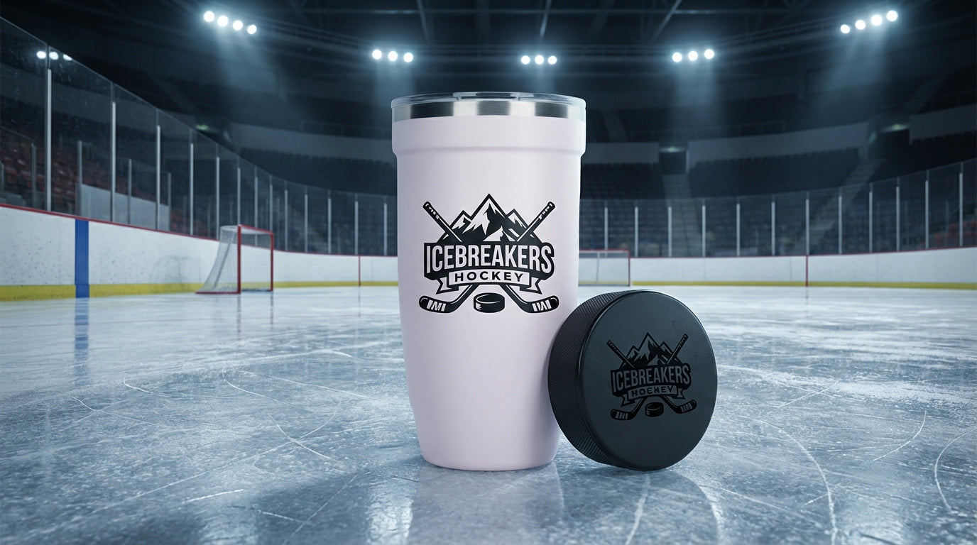 LAMOSE Baby Pink Peyto tumbler with custom engraving next to hockey puck