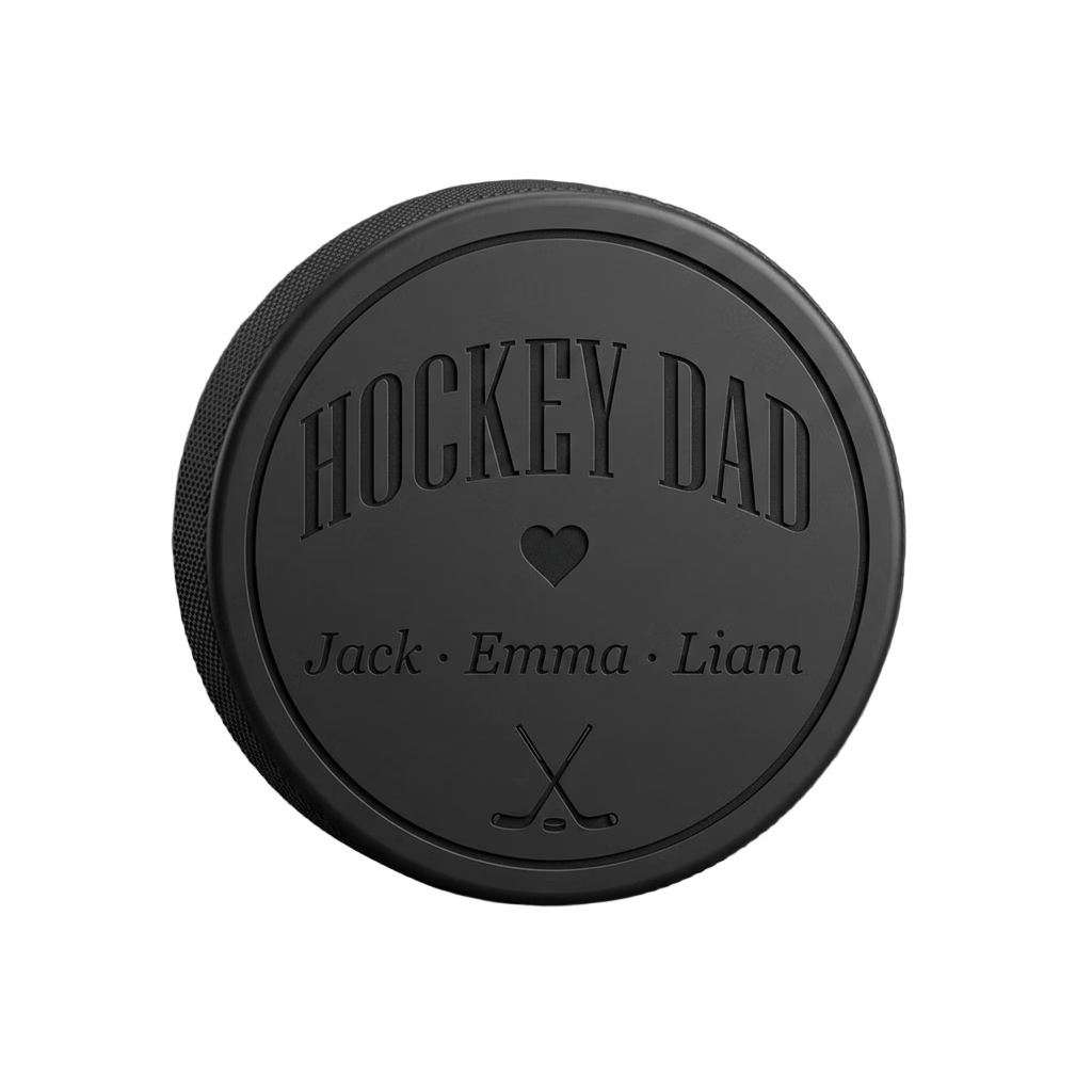 "Hockey Dad" + Kids' Names Engraved Hockey Puck — laser-engraved hockey puck, tonal black-on-black engraving on vulcanized rubber, made in Calgary