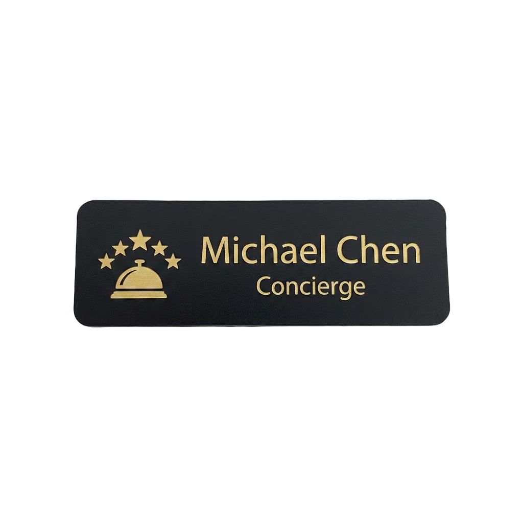 Hotel & Hospitality Name Tag — Concierge / Front Desk / Guest Services in Black / Gold — LAMOSE custom laser-engraved professional name tag, Trotec Trolase two-layer acrylic laminate (1.5 × 3 in.), made in Calgary, Canada since 2017.
