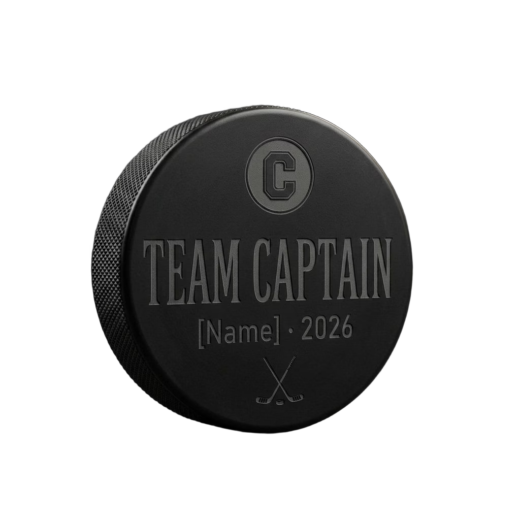 "Team Captain" Engraved Hockey Puck — laser-engraved hockey puck, tonal black-on-black engraving on vulcanized rubber, made in Calgary