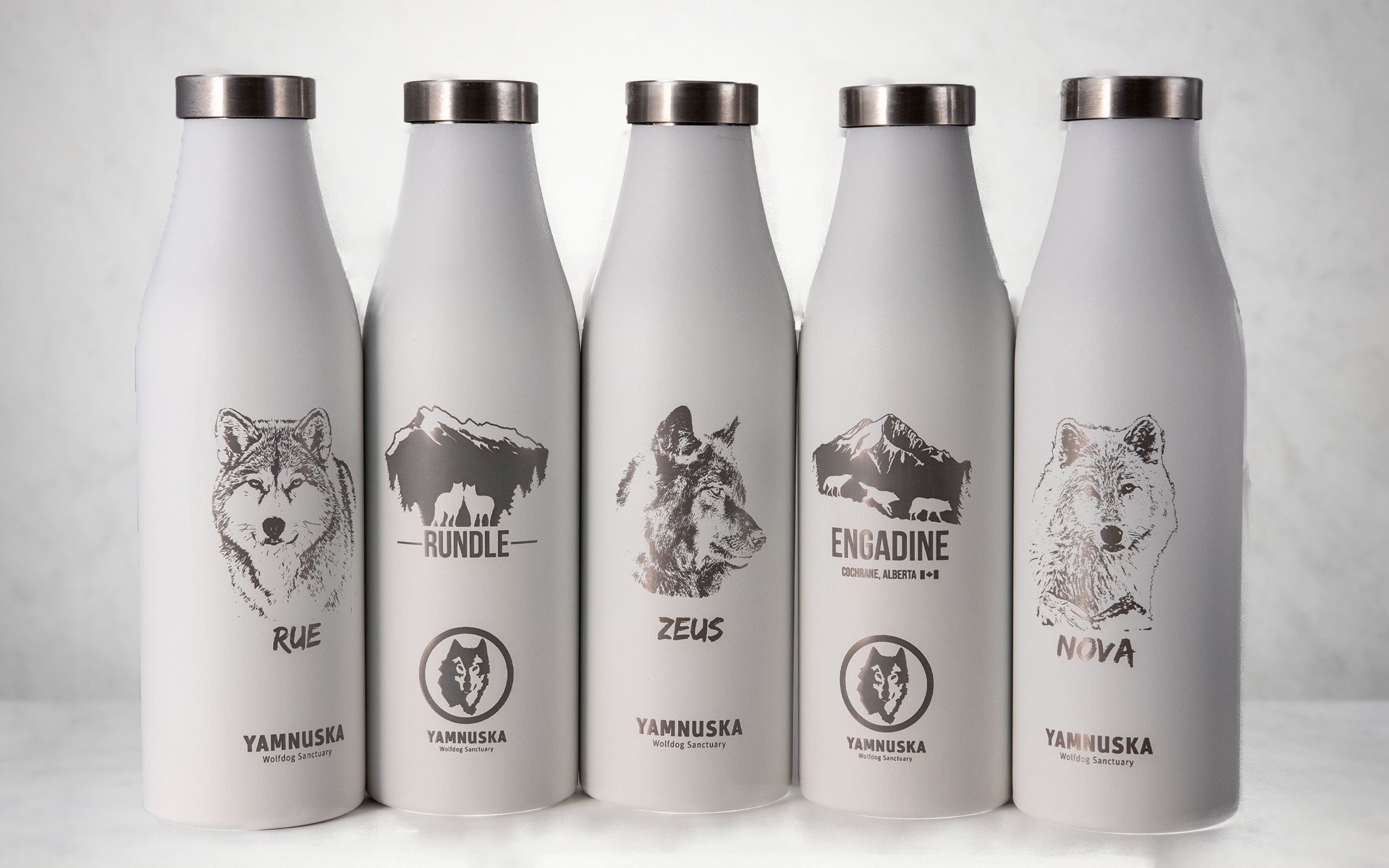 Custom LAMOSE water bottles featuring Yamnuska Wolfdog Sanctuary wolf designs