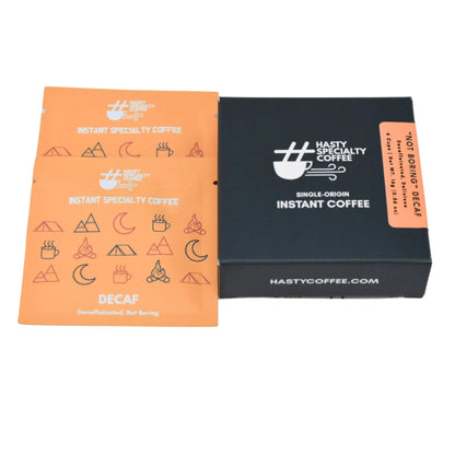 LAMOSE Hasty Specialty Decaf Instant Coffee black box and orange packet, top-down view, with logo, 'Decaf, Not Boring' text.