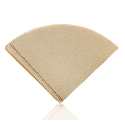 Stacked natural brown unbleached V01 cone coffee paper filters with a ribbed seam, shot from a slightly elevated angle. LAMOSE.