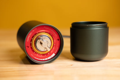 LAMOSE zeroHero Z7 manual coffee grinder in dark green, showing red grind settings for espresso & pour-over, metal body, low angle view.