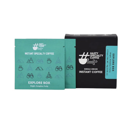 LAMOSE Hasty Coffee Explore Box with dark grey box, teal sachets, featuring camping icons for instant specialty coffee. Front view.