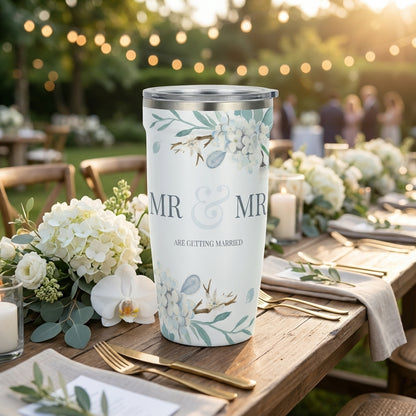 White 16oz travel tumbler featuring blue and white hydrangeas with text Mr & Mr Are Getting Married, set against a wedding background.