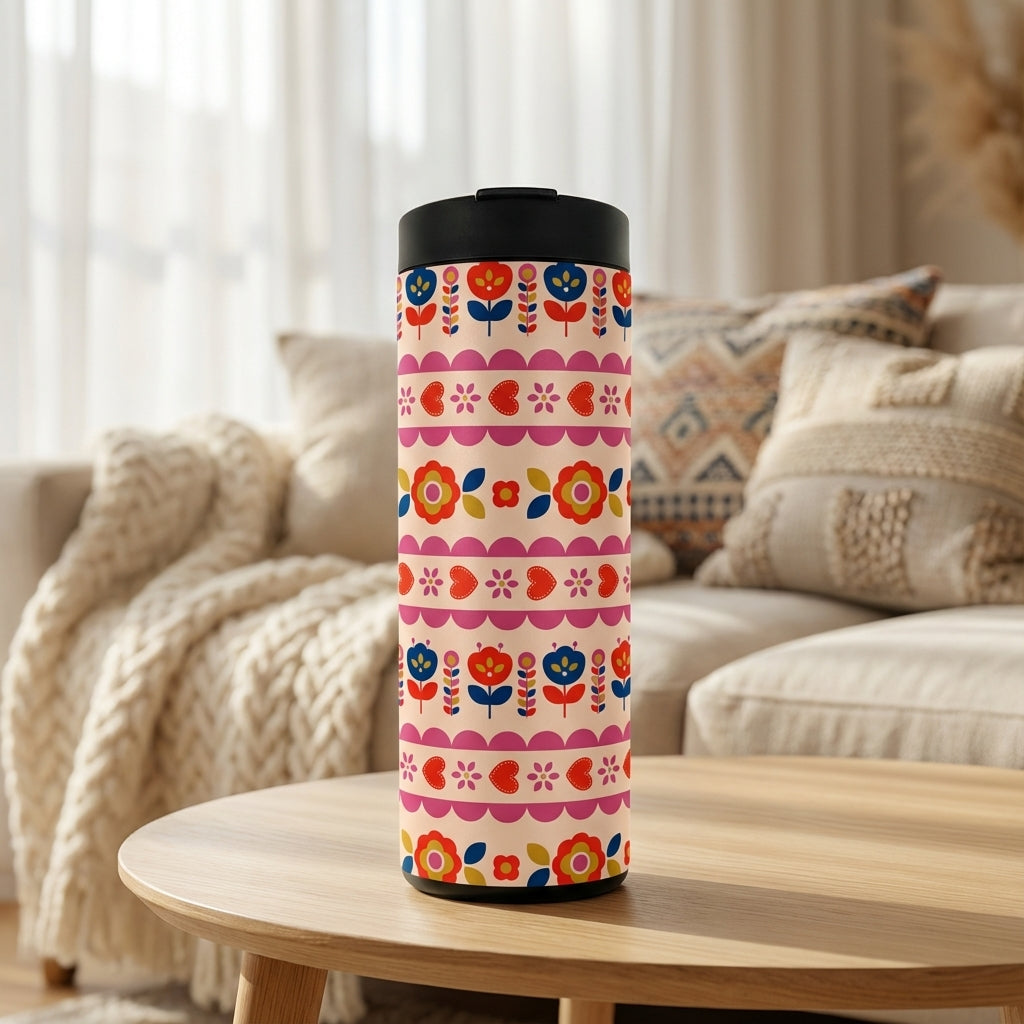Grouse 16 oz insulated tumbler featuring a colorful Scandinavian folk art floral and heart pattern in red, blue, and orange on a peach background.