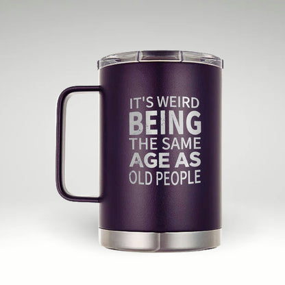 Aging with Humor: Insulated Mug Navy blue insulated mug with white text 'IT'S WEIRD BEING THE SAME AGE AS OLD PEOPLE' 