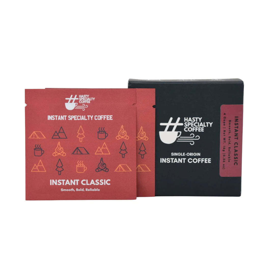 Hasty Coffee Instant Classic box featuring red instant coffee sachets and a black display box, angled front view. LAMOSE.