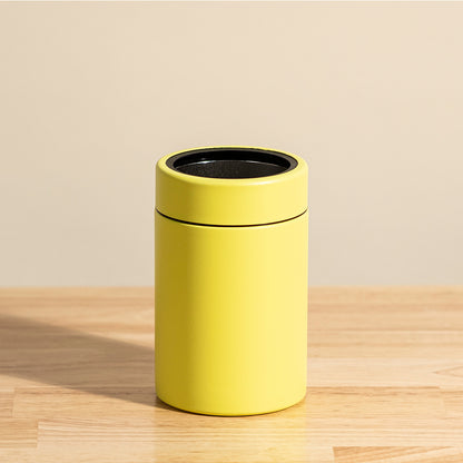 LAMOSE Logan 12 oz insulated yellow stainless steel can cooler tumbler, shown upright with a black rim on a wooden table.
