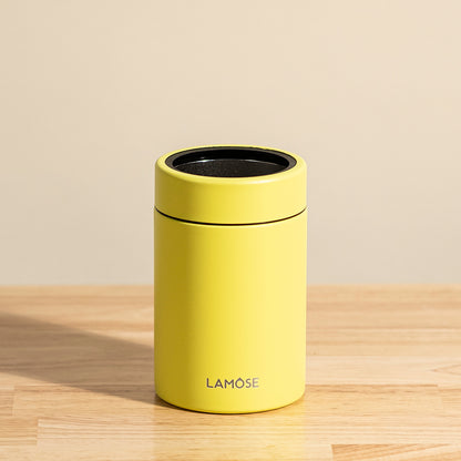 LAMOSE Logan 12 oz double-wall stainless steel yellow can cooler, front view on wood, with black rim and logo.