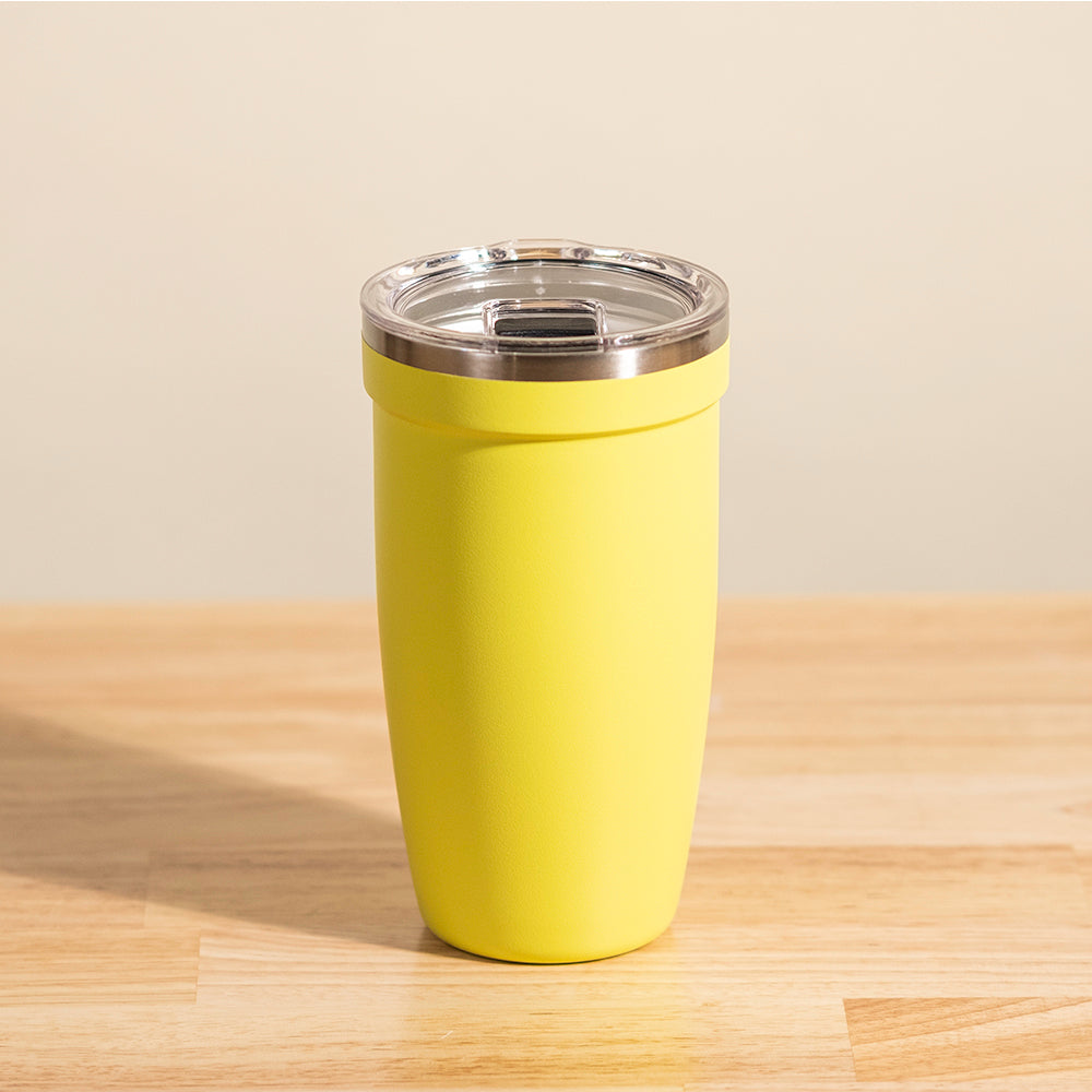 LAMOSE Peyto 16 oz yellow matte stainless steel tumbler with clear plastic and metal lid, front view on a wooden table.
