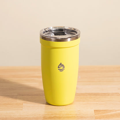 LAMOSE Peyto 16 oz yellow insulated stainless steel tumbler with clear lid and brand logo on a wooden surface, front view.