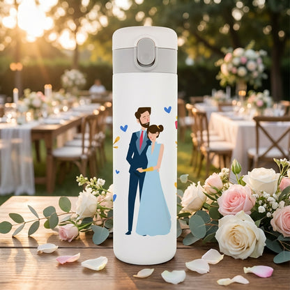 White LAMOSE Emerald 16oz tumbler featuring a printed illustration of a couple in wedding attire embracing, surrounded by blue and yellow hearts.