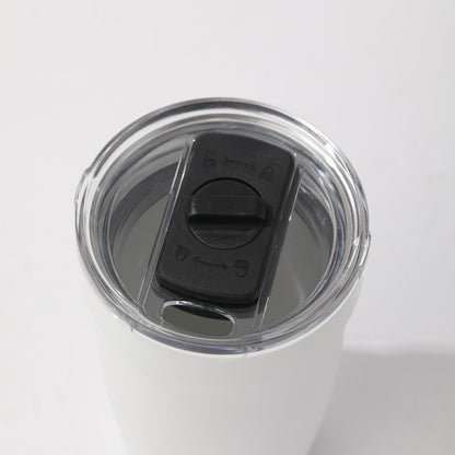 LAMOSE Peyto Pro Enamel 12oz snow white stainless steel tumbler, top view showing clear splash-proof lid with black slider and lock symbols.
