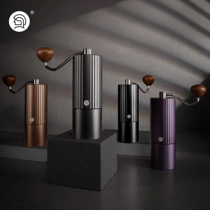 LAMOSE zeroHero Z3 Pro manual coffee grinders, a group of four in bronze, matte black, black, and purple, featuring a sleek ribbed metal body and wooden handles, displayed at eye-level.