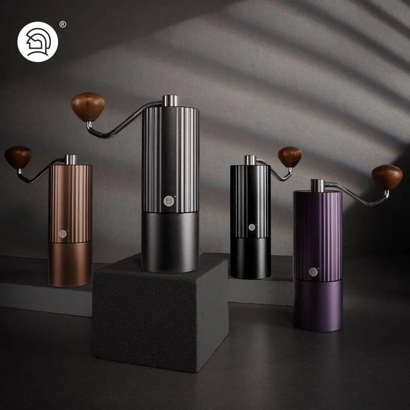 LAMOSE zeroHero Z3 Pro manual coffee grinders, a group of four in bronze, matte black, black, and purple, featuring a sleek ribbed metal body and wooden handles, displayed at eye-level.