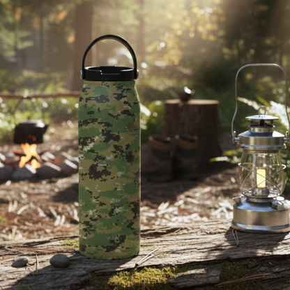 LAMOSE Grouse 34 oz insulated bottle featuring a green and brown pixelated digital camouflage pattern, resting on a natural surface.