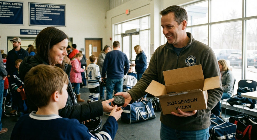 Parent volunteer holding box of laser engraved hockey pucks arena lobby