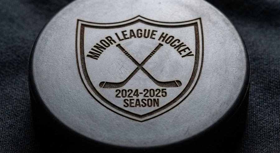 Close-up youth hockey team crest shield laser engraved on puck 2024-2025