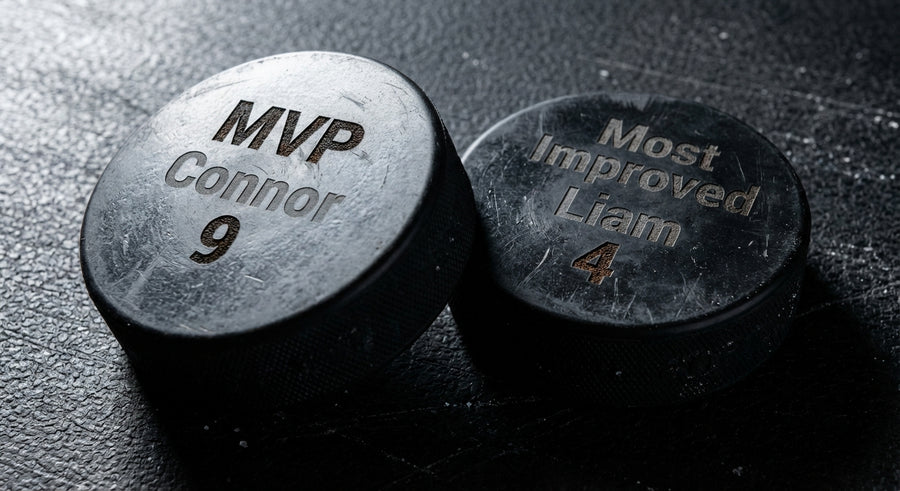 Two hockey pucks side by side MVP Connor 9 Most Improved Liam 4 engraved