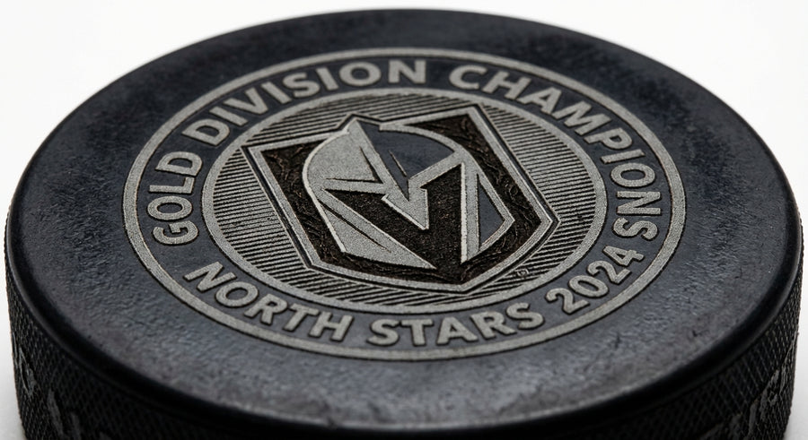 Close-up tournament puck detailed engraving shield logo Gold Division Champions