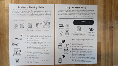Brew guides for espresso and Origami coffee brewing on white cards, laid flat on a light wood surface. Ideal for LAMOSE drinkware users.