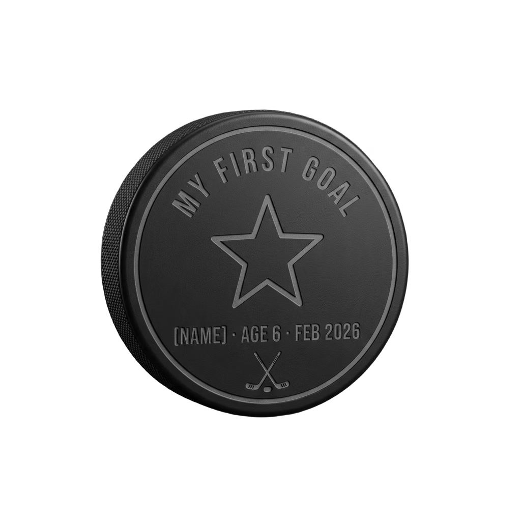 "My First Goal" Milestone Engraved Hockey Puck — laser-engraved hockey puck, tonal black-on-black engraving on vulcanized rubber, made in Calgary