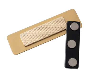 Veterinary Clinic Name Tag — Vet / Tech / Assistant (Custom) attachment system — gold-laminate name tag with textured adhesive pad and separate three-magnet housing in dark plastic. The two pieces sandwich the fabric for a secure hold with no pin holes. Made by LAMOSE in Calgary, Canada.
