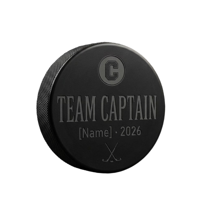 "Team Captain" Engraved Hockey Puck — laser-engraved hockey puck, tonal black-on-black engraving on vulcanized rubber, made in Calgary