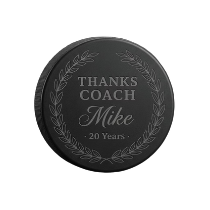 "Thanks Coach" Years of Service Engraved Hockey Puck — laser-engraved hockey puck, tonal black-on-black engraving on vulcanized rubber, made in Calgary