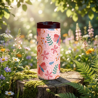Grouse 12 oz insulated tumbler in light pink featuring a pattern of red butterflies, pink flowers, green leaves, and orange rainbows.