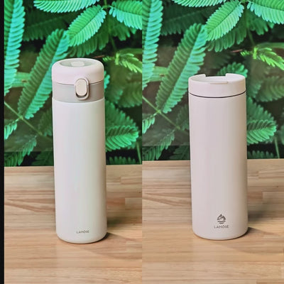 Minimalist off-white insulated tumblers from LAMOSE, featuring sleek leak-proof lids. Eco-friendly reusable travel mugs.