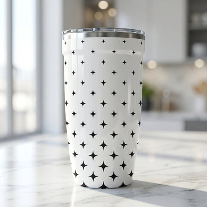White Peyto 16 oz insulated tumbler featuring a repeating black four-pointed star pattern sitting on a marble kitchen countertop.