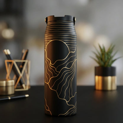 Matte black 34 oz water bottle featuring gold foil abstract wavy lines depicting a mountain landscape and sun.