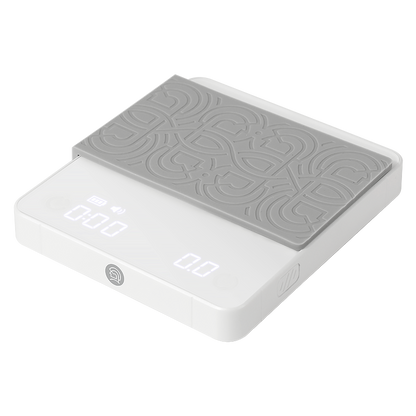 LAMOSE zeroHero mini white digital coffee scale, angled view, with gray patterned silicone mat and LED display showing timer and weight.